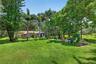 View of grounds to guest house. Beautiful seating area around the tree