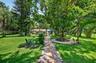 View of grounds to guest house. Beautiful seating area around the tree