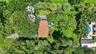 Grounds. Main house on right and guest house on left in mature garden setting
