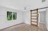 Second bedroom in Guest House with closet. Barn door provides access to a bonus room / office / 3rd bedroom