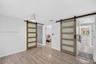 Second bedroom in Guest House with closet. One barn door provides access to a bonus room / office / 3rd bedroom in the guest house. The other leads to