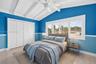 Large guest bedroom upstairs w/ views to front of house, beamed ceiling