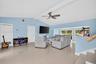 Living rm on main level. Primary bedroom to left. stairs up and down to the right. Volume beamed ceilings, impact windows, plantation shutters
