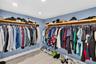 Oversized primary bedroom w/ beamed ceiling, Plantation Shutters and large walk in closet, en suite bathroom, on main level
