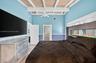 Oversized primary bedroom w/ beamed ceiling, Plantation Shutters and large walk in closet, en suite bathroom, on main level