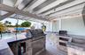 Outdoor Kitchen w/ Grill, Sink, Covered Seating, TV hookup