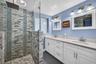 Oversized primary bedroom w/ beamed ceiling, Plantation Shutters and large walk in closet, en suite bathroom, on main level