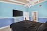 Oversized primary bedroom w/ beamed ceiling, Plantation Shutters and large walk in closet, en suite bathroom, on main level
