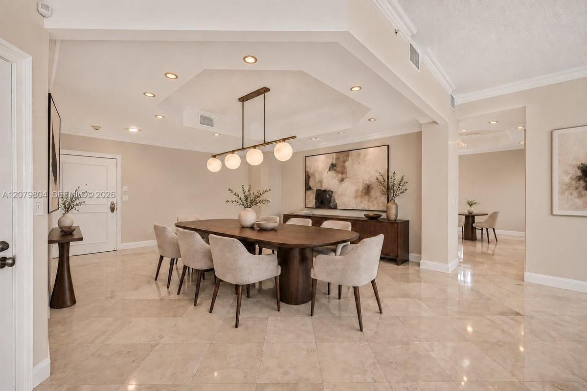 Virtually enhanced photo to visualize the space as a Dining Area, with kitchen behind it