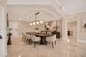 Virtually enhanced photo to visualize the space as a Dining Area, with kitchen behind it