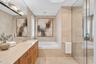 Virtually enhanced photo of the same primary bathroom, cleaned up