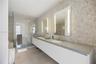 Floor-to-ceiling glass sliding door, balcony access, light-toned tile flooring, and neutral wall finishes