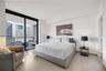 Private balcony featuring wood-finish tile flooring and a glass-paneled metal railing
