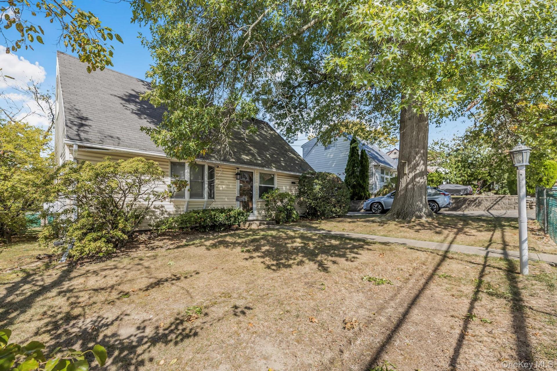 Rear view of property featuring roof with shingles