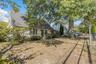 Rear view of property featuring roof with shingles