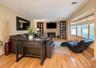 Wood-finish flooring throughout, a stone-clad fireplace, and integrated shelving fireplace with insert