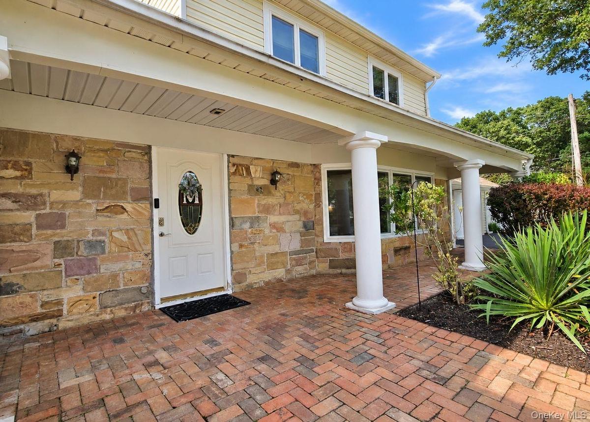 Brick paver entryway with stone facade accents