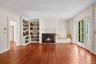 Expansive Living Room with Wood Burning Fireplace and Built-Ins