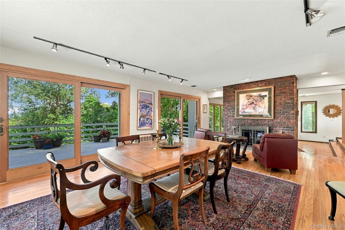 Formal Dining with Double Sided Fireplace and Balcony with Water Views