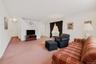 Carpeted living area with baseboards