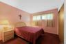 Carpeted bedroom with baseboards and a closet