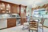 SS Bosch double oven, dishwasher and cooktop, vented hood, GE profile wine refrigerator and kitchenaide double door frig