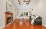 Family Room with Wood Burning FP, Beamed Cathedral Ceilings, and Window Seat