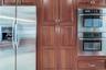 Stainless steel appliance including Bosch double oven and Kitchenaide French door refrigeraator with water and ice