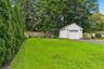 Yard framed by mature trees