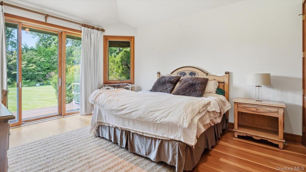 Guest bedroom at the end of the deck with access to pool and rear yard