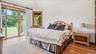 Guest bedroom at the end of the deck with access to pool and rear yard