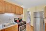 Additional cabinets and counter top next to the refrigerator