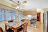 Natural wood-finish flooring, light-toned cabinetry, stainless steel range, and stainless steel refrigerator