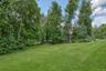 Expansive lawn surrounded by mature trees