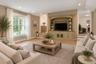View of this spacious family room, showcasing the abundance of windows, natural light, and inviting layout.