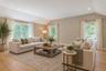 Bright, and spacious family room featuring and abundance of windows that fill the space with natural light, creating a warm and inviting atmosphere.