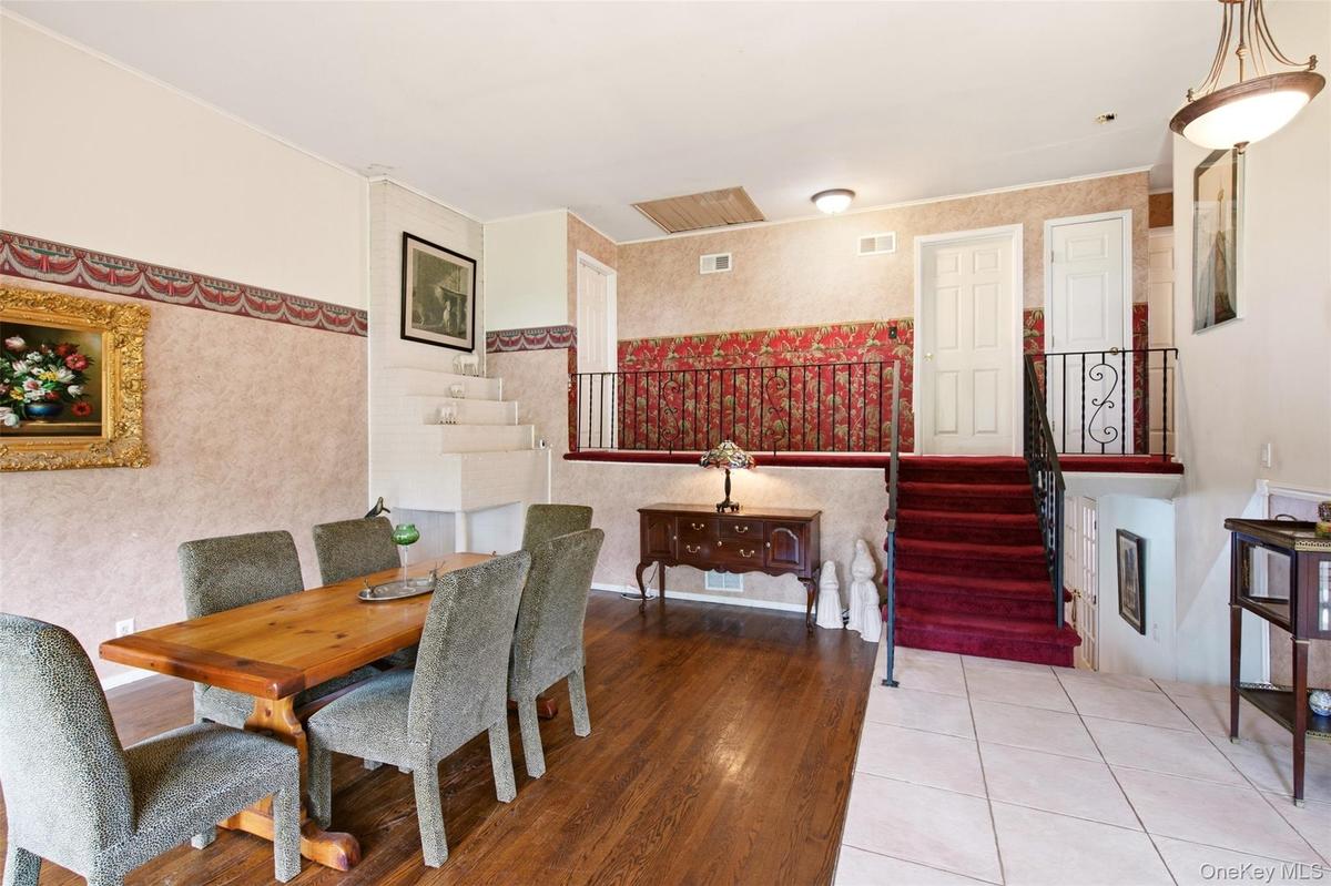 Open Living With Fireplace and High Ceiling Leading to Second Floor