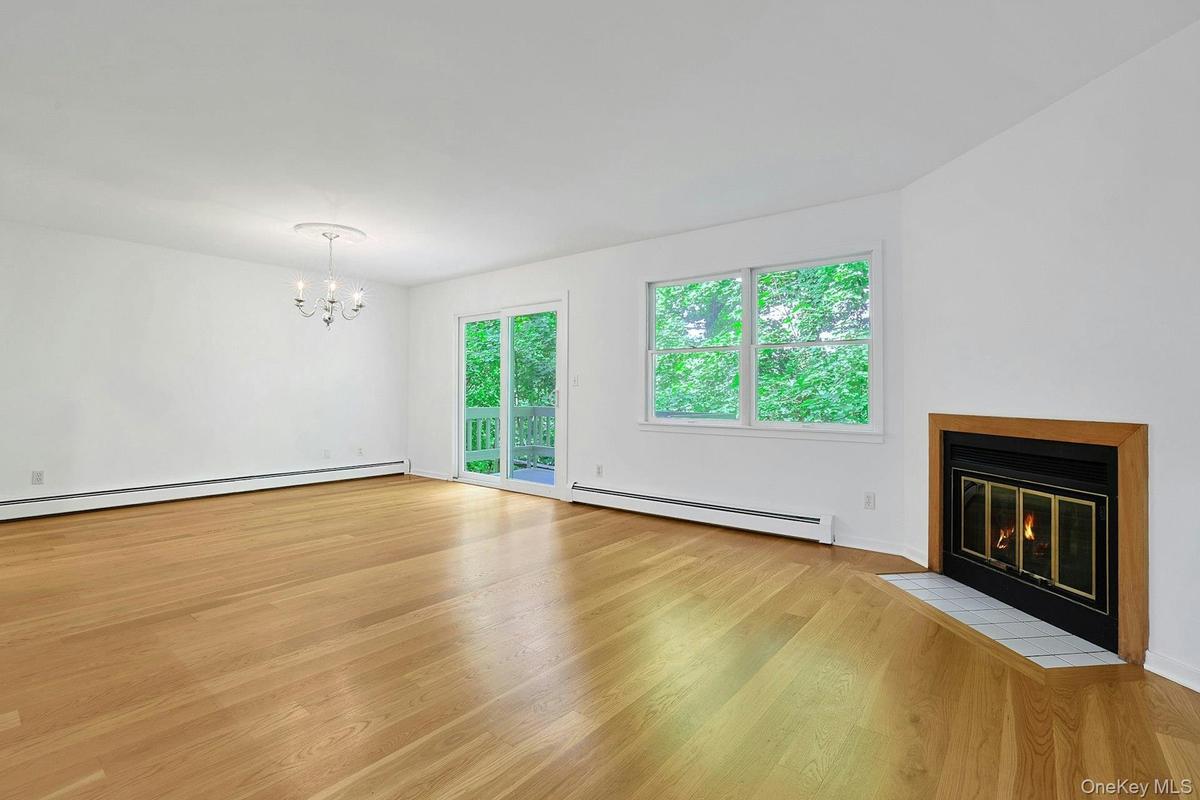 A wood-burning fireplace at the head of the living room is great for a crisp fall or winter evening. Open to the dining room - enjoy the crackling fir