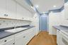 The well designed kitchen has abundant counter and cabinet space. The tried and true V layout for the double sink, oven and refrigerator works for a r