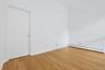 The loft would make for a great home office, library or den. The door on the left opens to the primary bedroom.