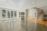 Great room off the kitchen with fireplace, French doors to the deck and yard.