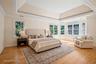Virtual staging. Primary room with two walk in closets, tray ceiling and spacious master bath.