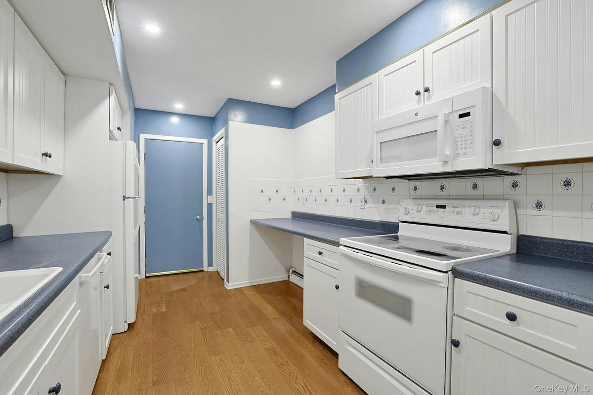 The beautiful ceramic tile backsplash makes cleaning easier and cabinets throughout the kitchen allow for abundant storage. There is space for every i