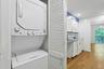 Conveniently located on the first floor, the laundry closet is hidden behind the slated doors. Just to the left is the garage door. Inside, the garage