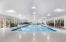 The large indoor community pool is protected from weather. Just a few steps from the home, this is an amazing amenity - literally in your backyard!