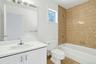 The private ensuite bathroom of the second bedroom is also tiled and has its own tub/shower. Whether for family or guests, this extra bathroom is a wo