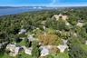 Lush, tree-lined neighborhood, view of the Hudson River and bridge.