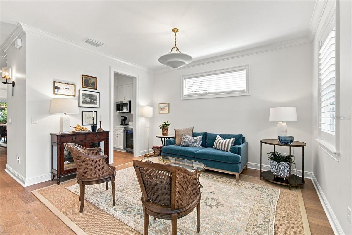 High ceilngs, wood floors, crown molding carry throughout the home