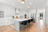 Classic design with shaker cabinets & quartz counters, in white and soothing tones.