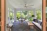Tongue and grove ceiling and wood details add character to the screened porch.